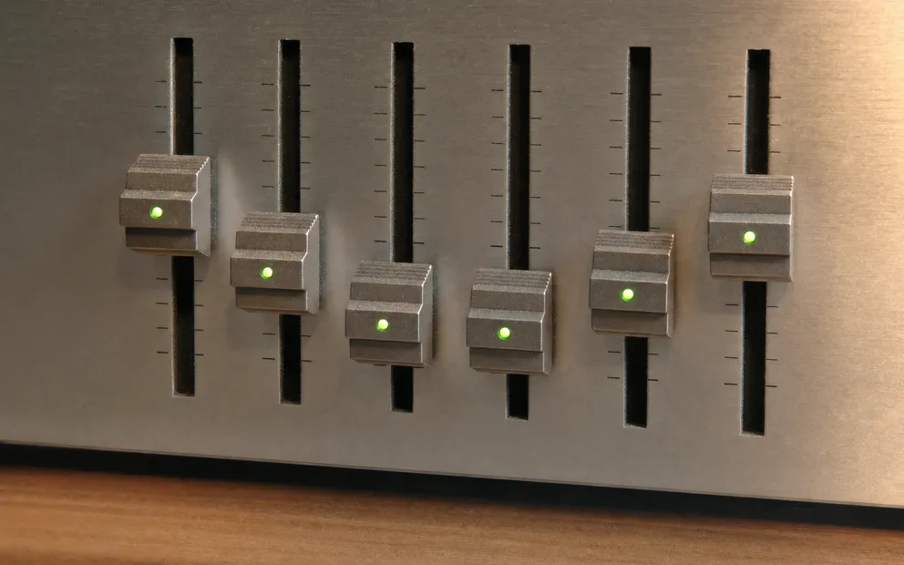 Close-up of a six-band graphic equalizer with each frequency label lit, sliders set in a gentle curve