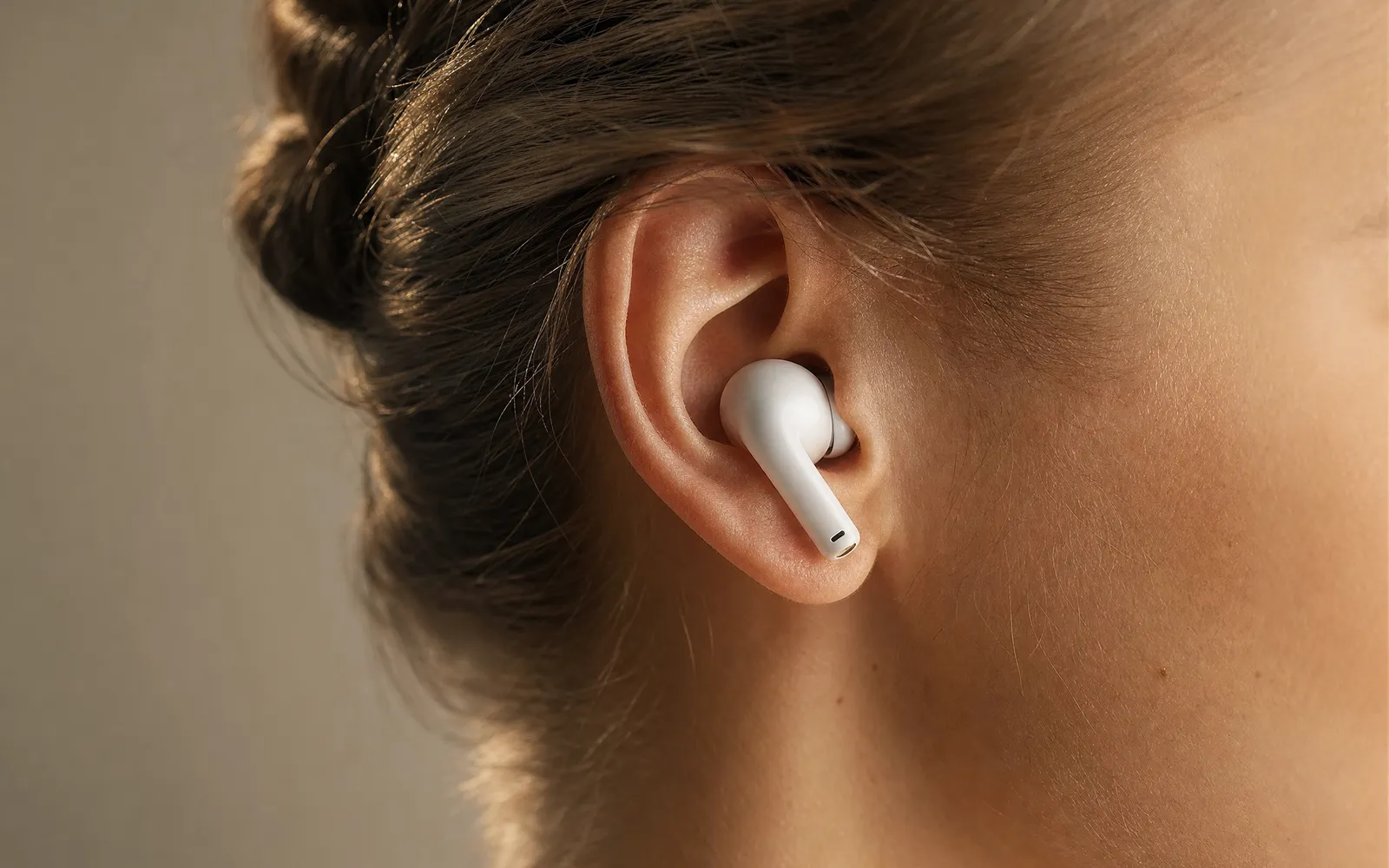 Side view of an ear with a wireless earbud seated in the ear canal